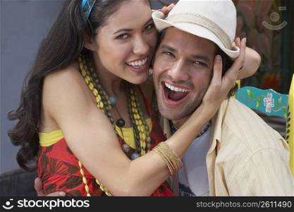Portrait of a young couple embracing each other and smiling