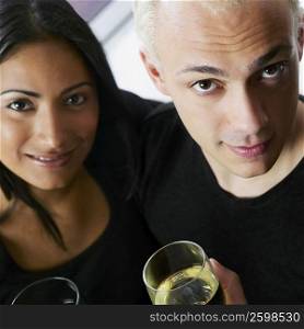 Portrait of a young couple holding a glass of wine
