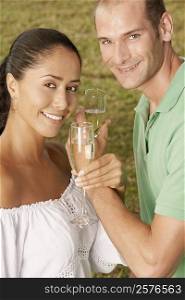 Portrait of a young couple holding champagne flutes