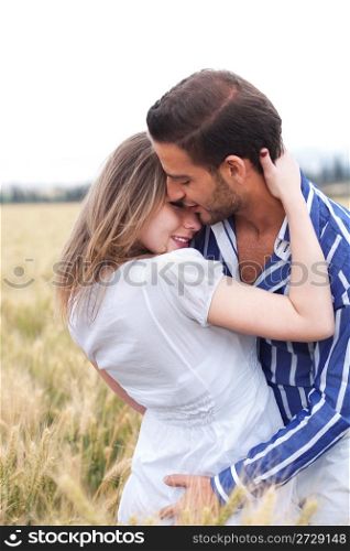 Portrait of a young Couple hugging and kissing eachotherr in the park