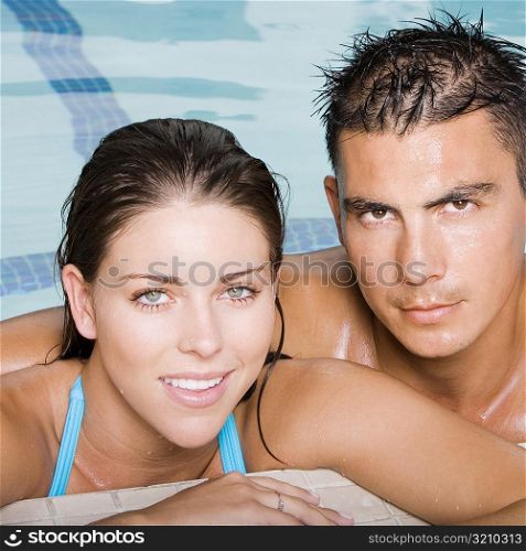 Portrait of a young couple in a swimming pool