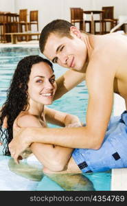 Portrait of a young couple in a swimming pool