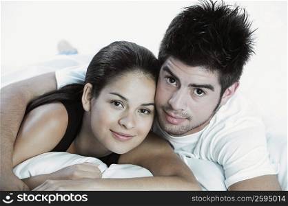 Portrait of a young couple lying on the bed