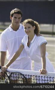 Portrait of a young couple on a tennis court