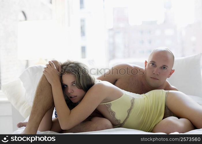 Portrait of a young couple romancing on the bed