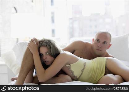Portrait of a young couple romancing on the bed
