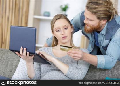 portrait of a young couple shopping online