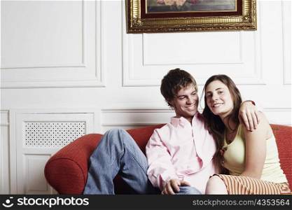 Portrait of a young couple sitting on a couch