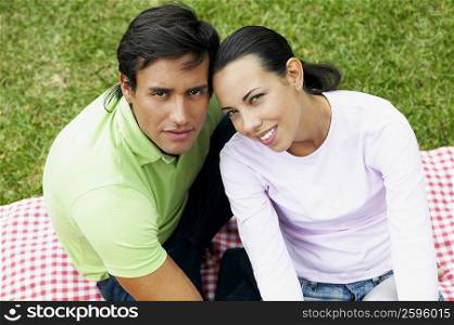 Portrait of a young couple sitting on a picnic blanket