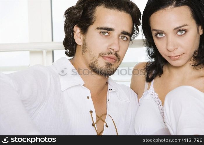 Portrait of a young couple sitting side by side