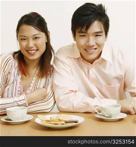 Portrait of a young couple sitting together and smiling