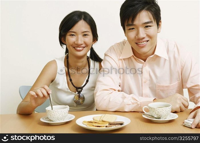 Portrait of a young couple sitting together and smiling
