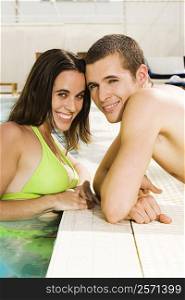Portrait of a young couple smiling at the poolside