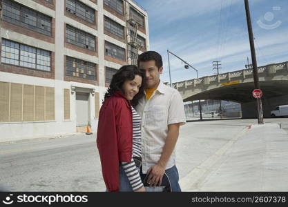 Portrait of a young couple standing at the roadside