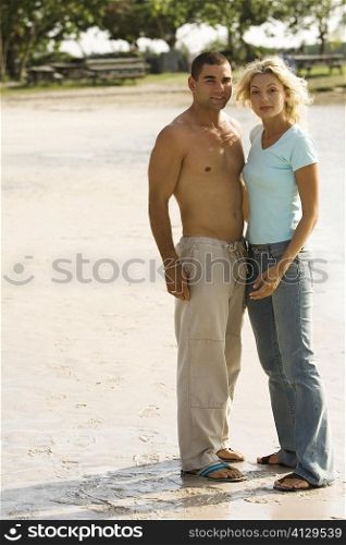 Portrait of a young couple standing on the beach