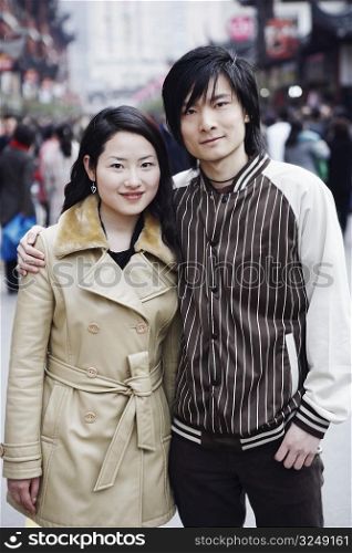 Portrait of a young couple standing together smiling