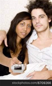 Portrait of a young couple watching television