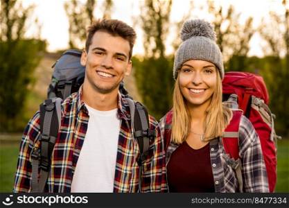 Portrait of a young couple with backpacks ready for c&ing