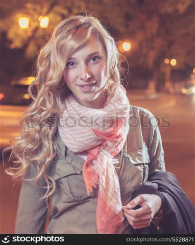 Portrait of a young female businesswoman in night city. Close-up, shallow DOF.