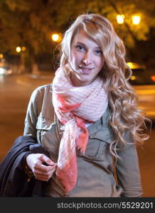 Portrait of a young female businesswoman in night city. Close-up, shallow DOF.