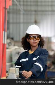 Portrait of a young female engineer in the welding robot industry, posed like a top model.