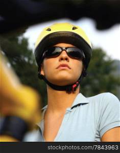 portrait of a young female in a cycling helmet looking concerned - intentional shallow depth of field