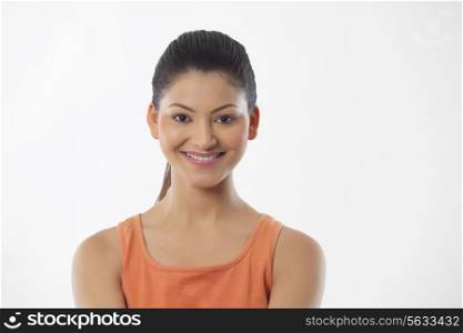 Portrait of a young fitness woman smiling over white background