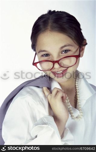 Portrait of a young girl dressed as a businesswoman smiling