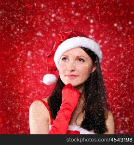 Portrait of a young girl dressed as Santa Claus on a red background. Happy New Year and Merry Christmas!