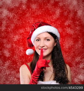 Portrait of a young girl dressed as Santa Claus on a red background. Happy New Year and Merry Christmas!