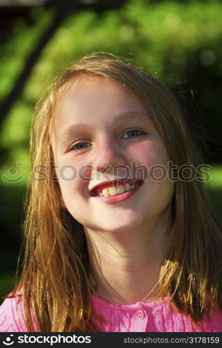 Portrait of a young girl in a summer park