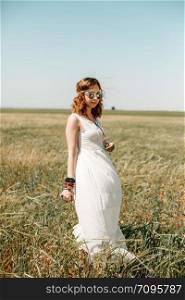 portrait of a young girl in a white translucent dress in boho or hippie style