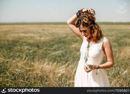 portrait of a young girl in a white translucent dress in boho or hippie style