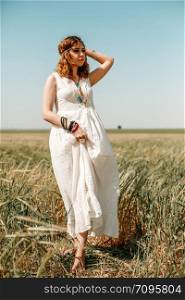 portrait of a young girl in a white translucent dress in boho or hippie style