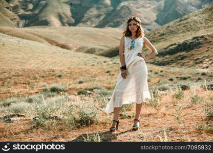 portrait of a young girl in a white translucent dress in boho or hippie style