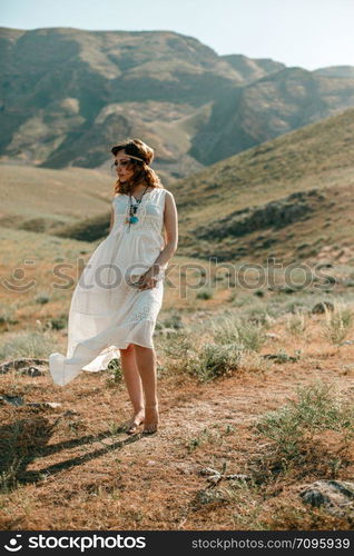 portrait of a young girl in a white translucent dress in boho or hippie style