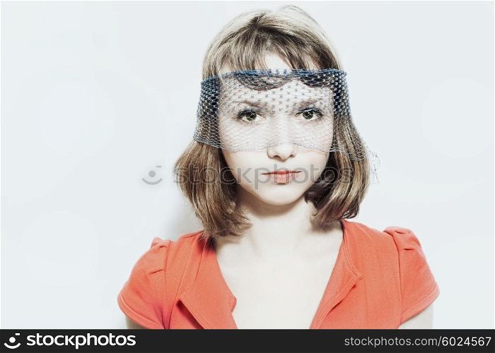 Portrait of a young girl in the veil on a white background