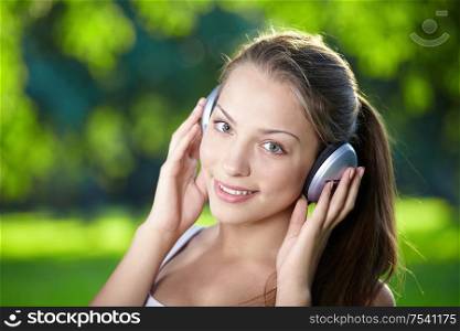 Portrait of a young girl listening to music with headphones