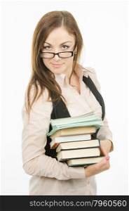 Portrait of a young girl of twenty-five teachers or office specialist. Portrait of a teacher with a heap of textbooks and notebooks