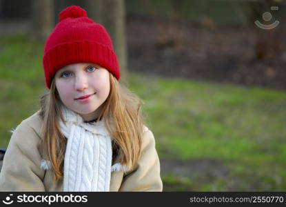 Portrait of a young girl sitting on a bench