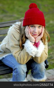 Portrait of a young girl sitting on a bench