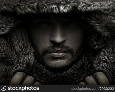 Portrait of a young guy in fur hood