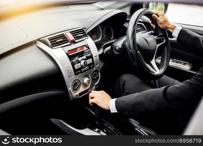 Portrait of a young handsome businessman driving a luxury sports car (rich).. Portrait of a young handsome businessman driving a luxury sports