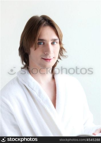 portrait of a young handsome man in bath robe