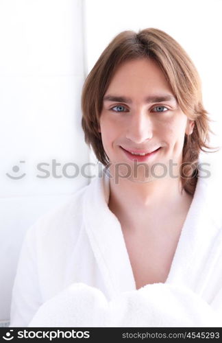 portrait of a young handsome man in bath robe