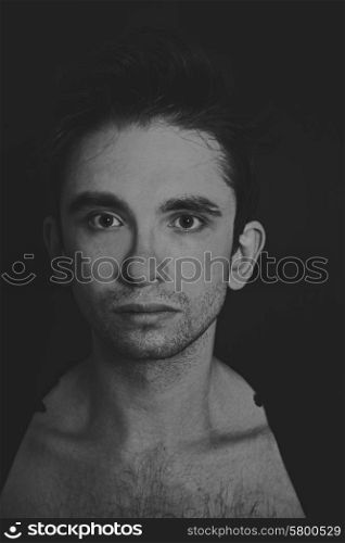 Portrait of a young handsome man on black background