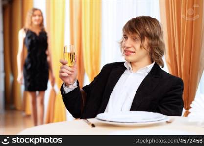 Portrait of a young handsome man sitting in restaurant