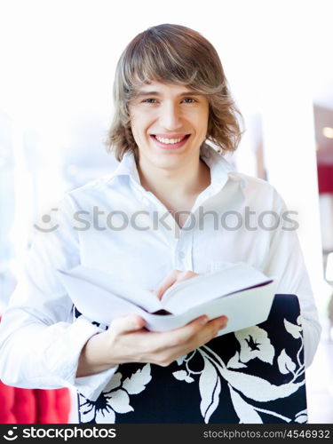 portrait of a young handsome man with a book