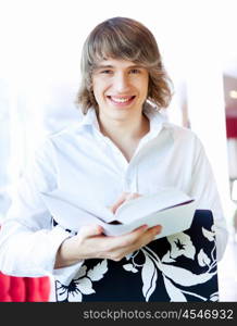 portrait of a young handsome man with a book