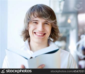 portrait of a young handsome man with a book